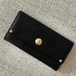 Henri Bendel black pebble leather magnetic flap wallet.